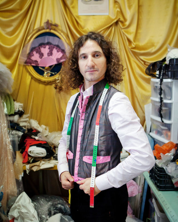 Portrait of a tailor posing in his workshop