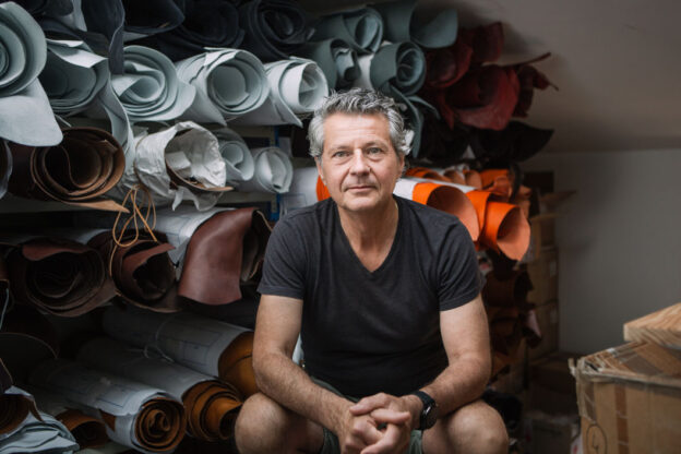Portrait of Alain Rondini, seated in his workshop's leather store