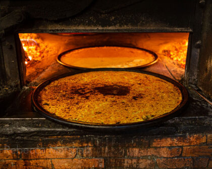 Photograph of two trays of socca in the oven