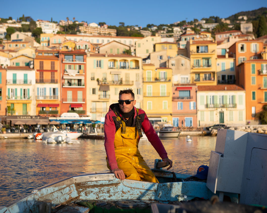 Fisherman sails out to sea from a village in Provence on a sunny day in a pointu, a traditional fishing boat